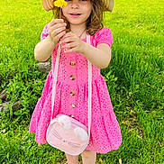 Ola is registered to the contest to win money with this photo: child, girl, flower, dandelion, pink_dress, hat, sandals, grass, tree, outdoor, nature, smiling, greenery, bag, summer, cute, happy, standing, portrait, playful