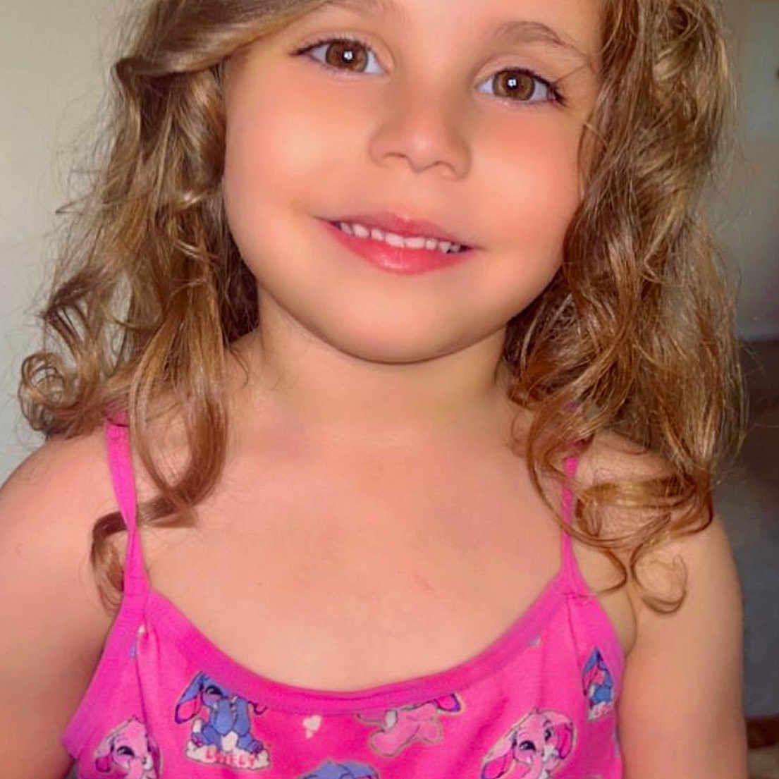 Ola is registered to the contest to win money with this photo: cartoon_bunny, child, childhood, clothing, curly_hair, cute, eyebrows, eyes, face, fashion, girl, happy, indoor, person, pink_dress, portrait, shoulders, skin, smiling, young