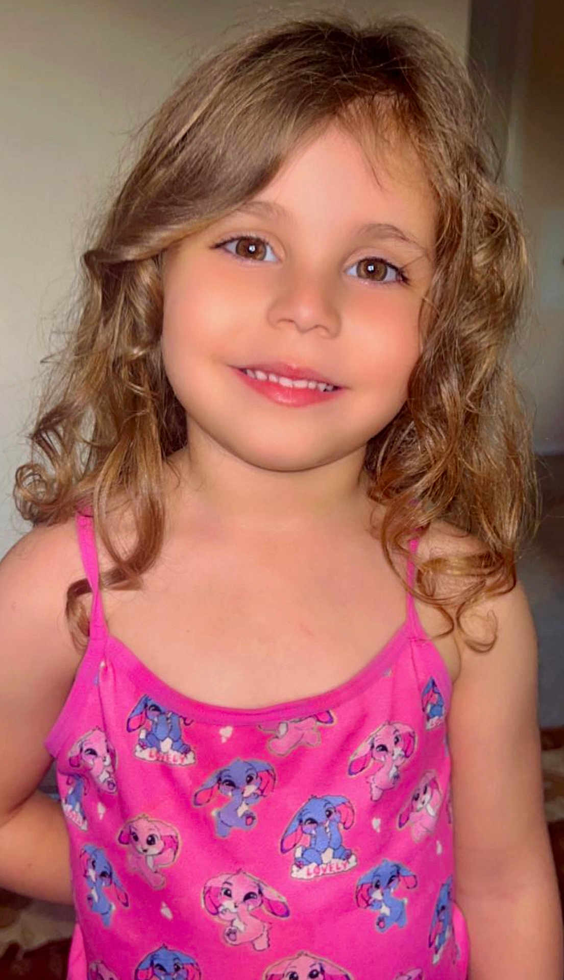 Ola is registered to the contest to win money with this photo: child, smiling, curly_hair, pink_dress, cartoon_bunny, indoor, portrait, cute, young, face, happy, person, clothing, fashion, girl, childhood, eyebrows, skin, eyes, shoulders