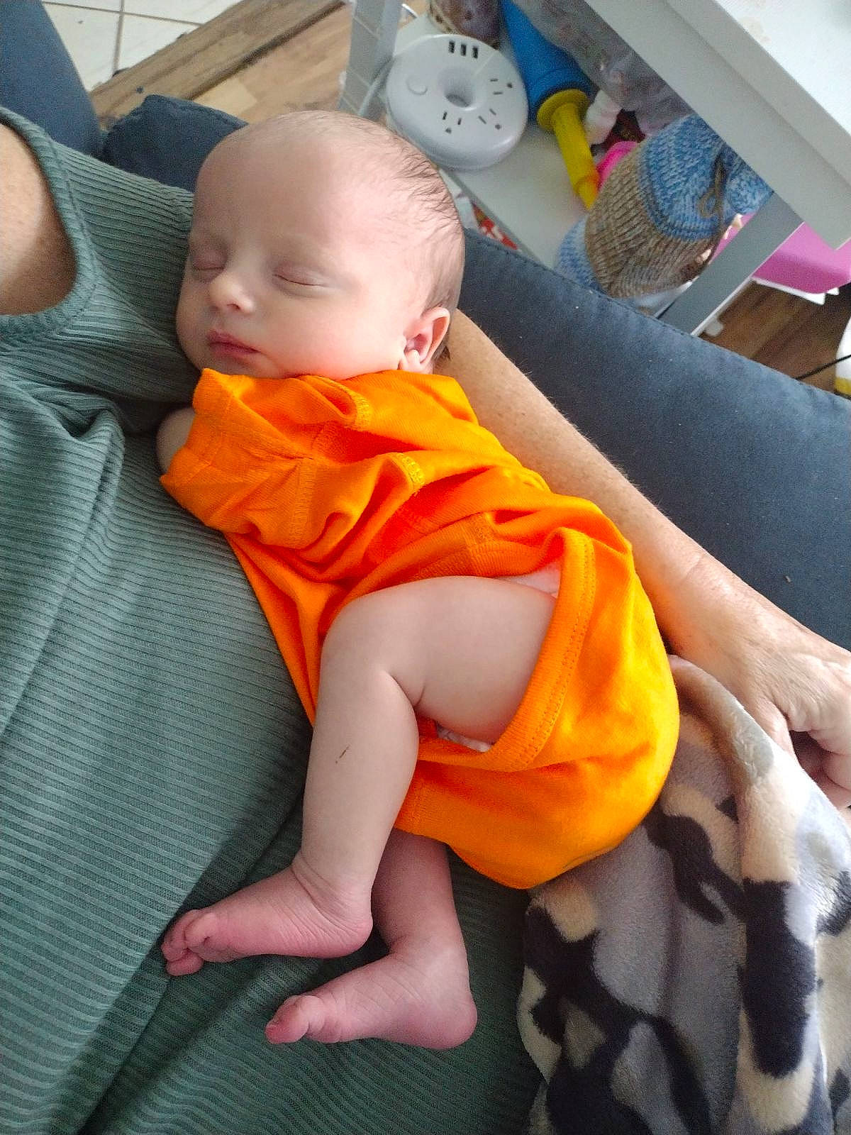 Harrison joined the competition — help win amazing prizes! abdomen, baby, baby_products, baby_toddler_clothing, chair, cheek, child, comfort, finger, head, human_leg, lap, leg, mouth, orange, person, room, sitting, skin, thigh