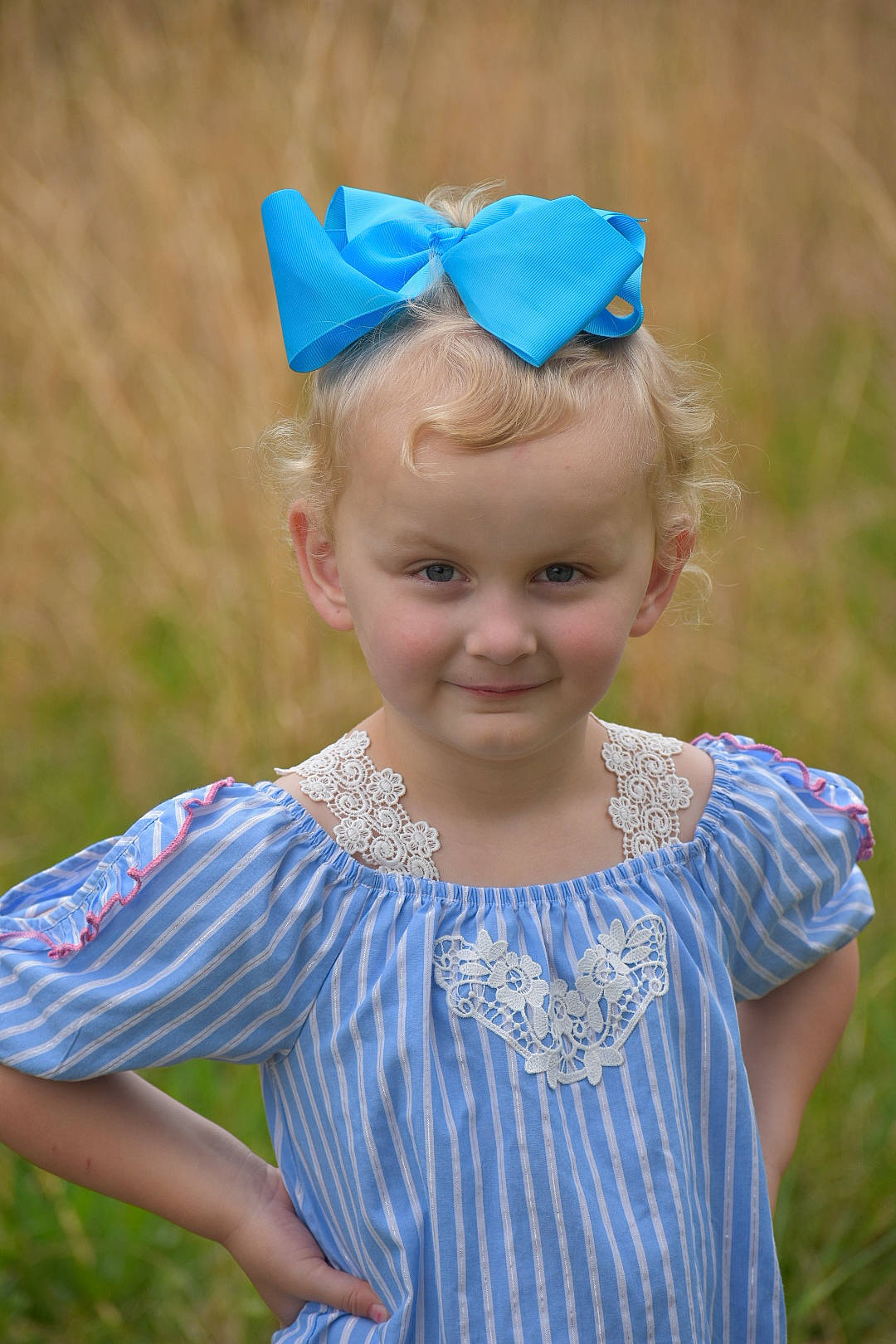 Mckenna is registered to the contest to win money with this photo: azure, baby_toddler_clothing, blond, child, clothing, electric_blue, eye, face, facial_expression, fun, grass, happy, head, headband, headgear, headpiece, iris, jewellery, joy, person