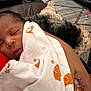 Elijah joined the competition — help win amazing prizes! newborn, baby, blanket, orange, sleeping, person, dog, curly_hair, hand, arm, indoor, rug, leather_sofa, comfort, rest, cozy, home, closeup, human, pet