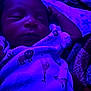Elijah is registered to the contest to win money with this photo: baby, sleeping, blanket, animal_print, purple_light, infant, cozy, bed, resting, peaceful, child, pajamas, soft_light, portrait, indoor, cute, newborn, relaxing, comfort, calm