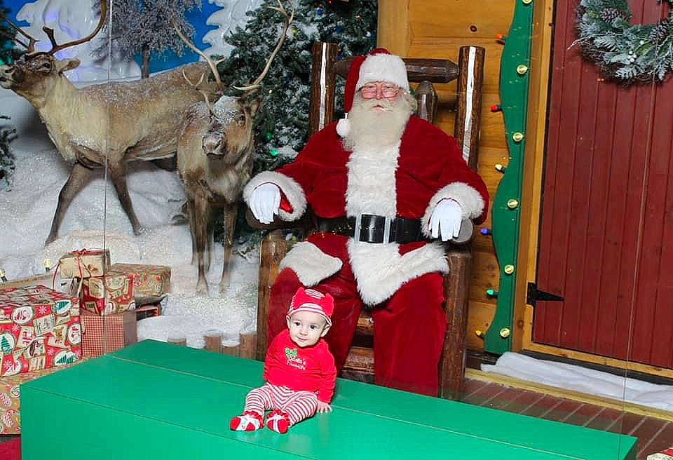 Aria Grace is registered to the contest to win money with this photo: blue, christmas, christmas_decoration, christmas_eve, christmas_ornament, event, fictional_character, fun, green, headwear, holiday, holiday_ornament, lap, leisure, ornament, person, red, santa_claus, snow, toy