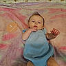 baby, infant, blue_outfit, blanket, tie_dye, age_sign, 4_months, lying_down, cute, hand, exploring, soft_texture, indoors, child, person, portrait, young, skin, small_hands, resting