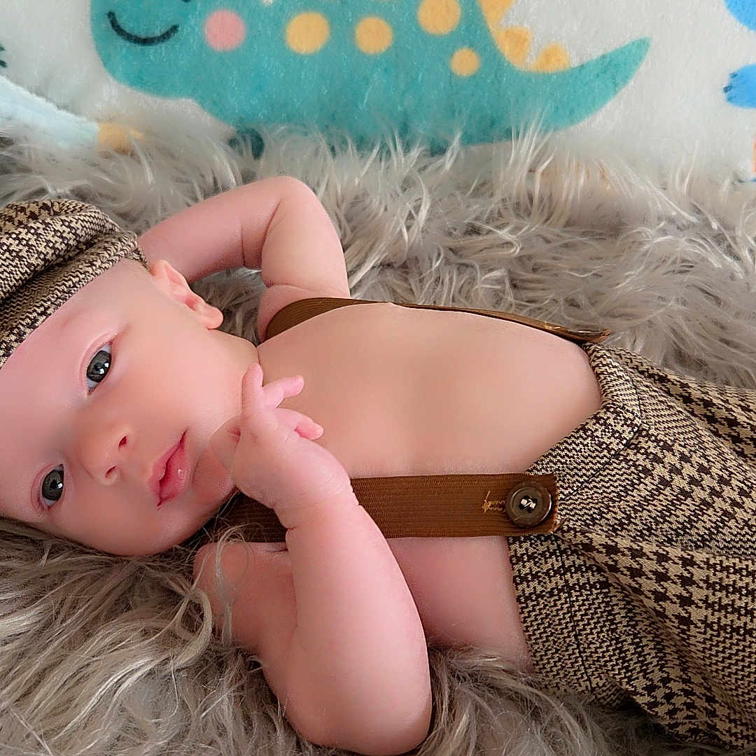 Grayson joined the competition — help win amazing prizes! baby, infant, cute, fluffy_rug, suspenders, hat, dinosaur_blanket, hearts, lying_down, portrait, child, soft_texture, cozy, smiling, indoors, colorful_background, skin, baby_fashion, adorable, relaxed