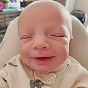 Grayson joined the competition — help win amazing prizes! baby, smiling, infant, close_up, face, eyes_closed, indoors, clothing, cute, child, soft_lighting, portrait, newborn, seat, baby_outfit, happy, small_person, baby_face, home, cozy