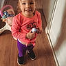 Journee joined the competition — help win amazing prizes! toddler, child, indoor, wooden_floor, pink_clothing, purple_pants, toy, baby_walker, smiling, pigtails, footwear, door, home_interior, person, young_child, cute, standing, happy, casual_wear, playtime