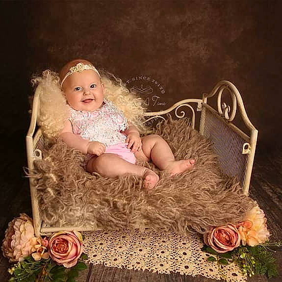 Holly is registered to the contest to win money with this photo: baby, child, doll, fur, headpiece, joy, person, photography, pink, product, sitting, toddler, wedding_ceremony_supply