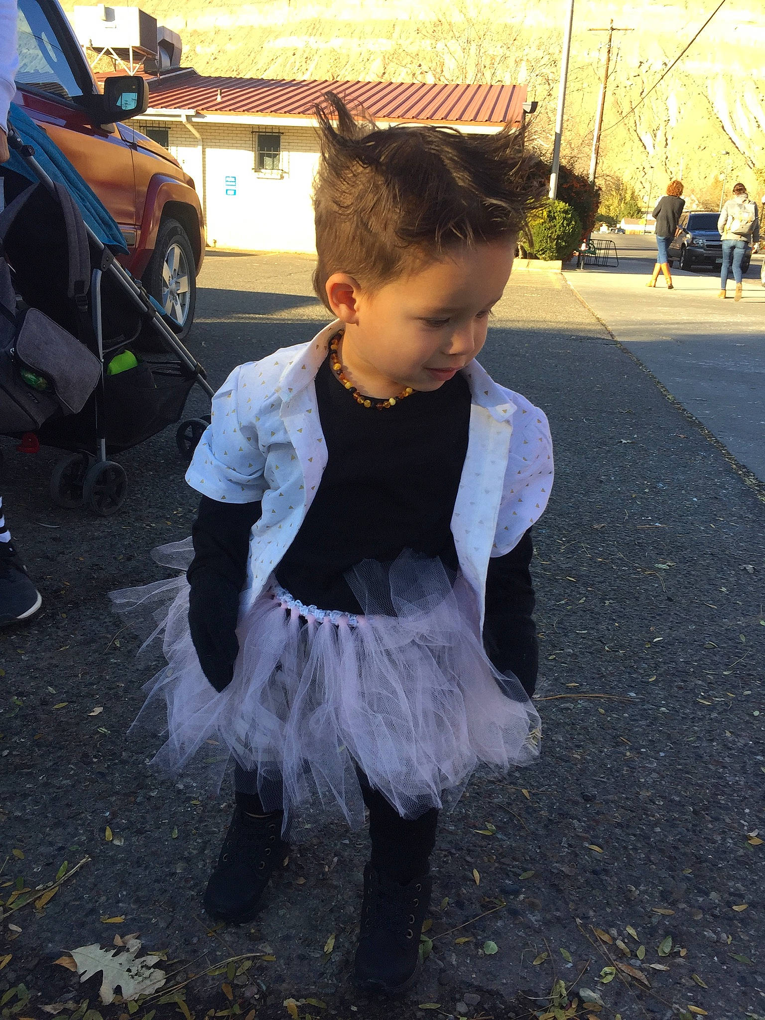 Silas is registered to the contest to win money with this photo: asphalt, child, event, fashion_accessory, fun, fur, grass, luxury_vehicle, pedestrian, person, public_space, road, road_surface, sidewalk, standing, street, tints_and_shades, tire, toddler, vehicle_door