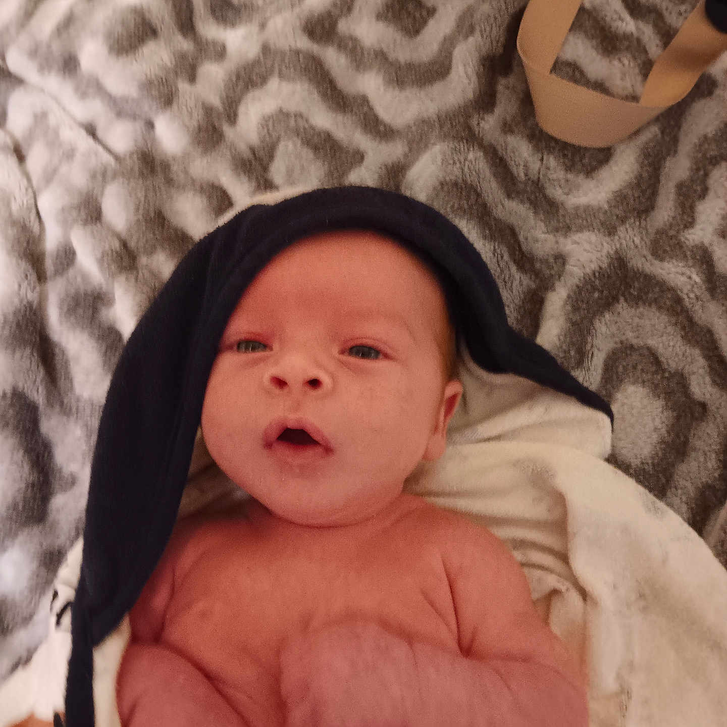 Sean Jr. joined the competition — help win amazing prizes! baby, blanket, bodypart, bonnet, cap, clothing, face, finger, hand, hat, head, hood, hoodie, knitwear, newborn, person, photography, portrait, sweater, towel