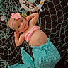 Astrid is registered to the contest to win money with this photo: accessories, baby, bed, bodypart, bonnet, cap, clothing, dress, face, finger, furniture, glove, hand, hat, head, newborn, person, photography, portrait, toy