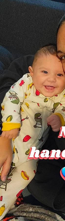 Sebastian is registered to the contest to win money with this photo: baby, baby_products, baby_toddler_clothing, cheek, child, chin, collar, face, finger, fun, gesture, happy, joy, pattern, person, sitting, skin, sleeve, smile, t_shirt