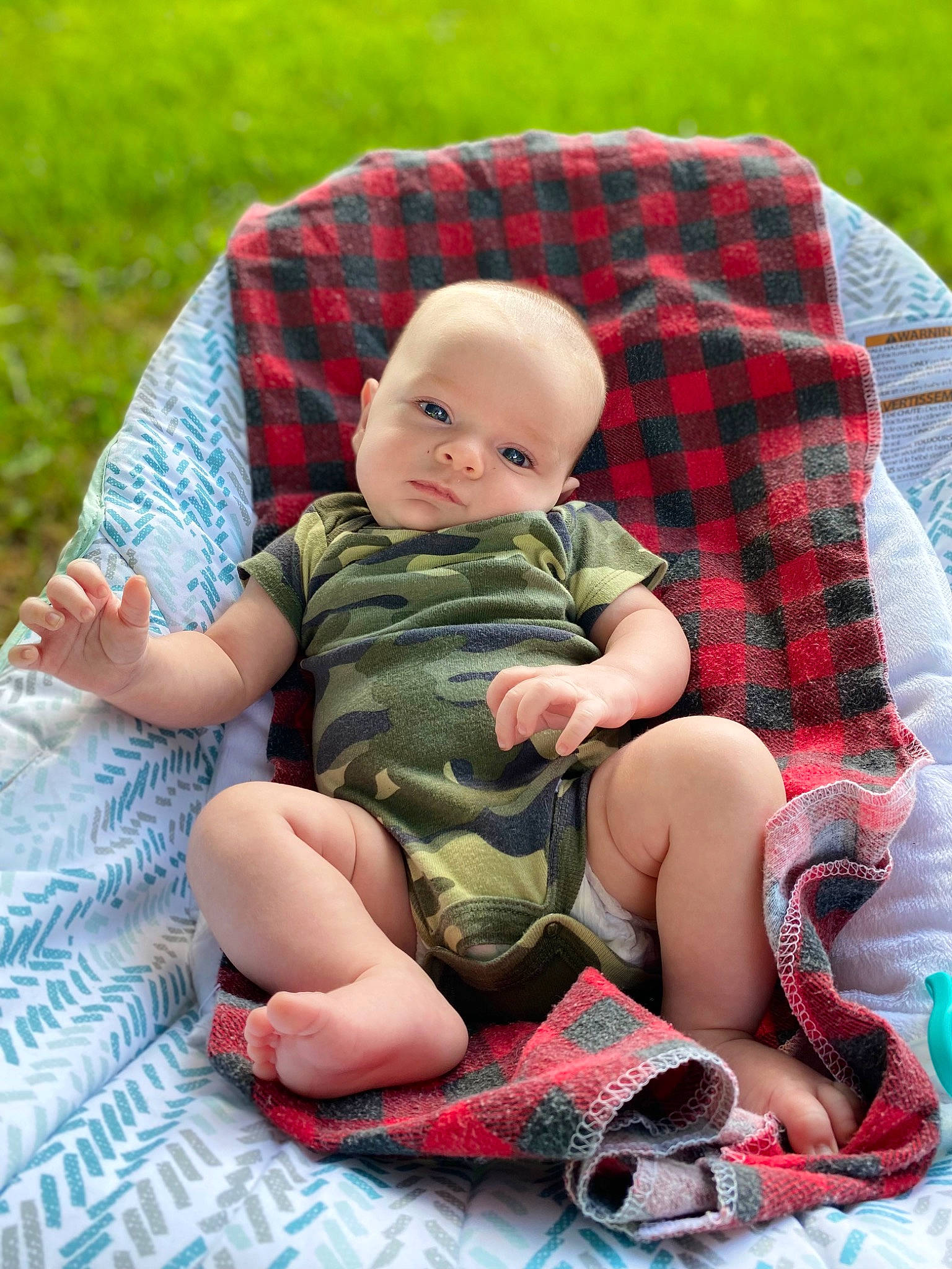 Dallas joined the competition — help win amazing prizes! baby, baby_products, baby_toddler_clothing, child, comfort, foot, grass, happy, lap, pattern, people_in_nature, person, plaid, product, recreation, sitting, skin, sock, tartan, thigh