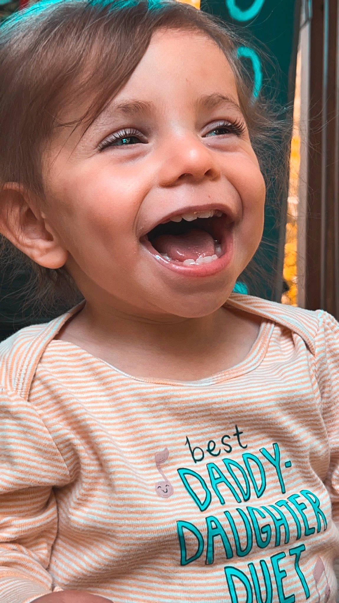 Charleigh is registered to the contest to win money with this photo: cheek, chin, curtain, eyelash, fun, gesture, happy, iris, jaw, lip, mouth, nose, person, pink, skin, sleeve, smile, t_shirt, toddler, tongue