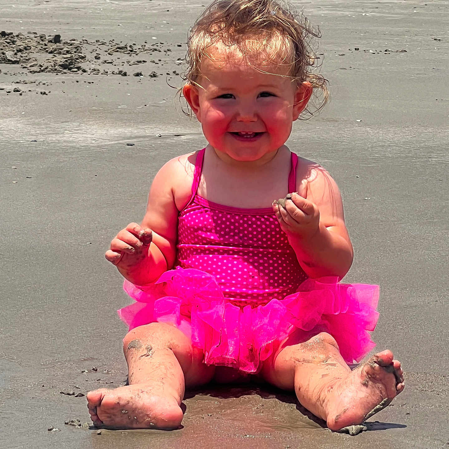 Jaelynn is registered to the contest to win money with this photo: baby, barefoot, beach, bodypart, clothing, coast, dress, face, finger, hand, head, nature, outdoors, person, photography, portrait, sea, shoreline, sitting, water