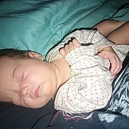 Serenity is registered to the contest to win money with this photo: baby, sleeping, infant, onesie, polka_dots, blanket, soft, peaceful, child, resting, cute, skin, face, hand, cozy, indoor, closeup, newborn, person, comfort