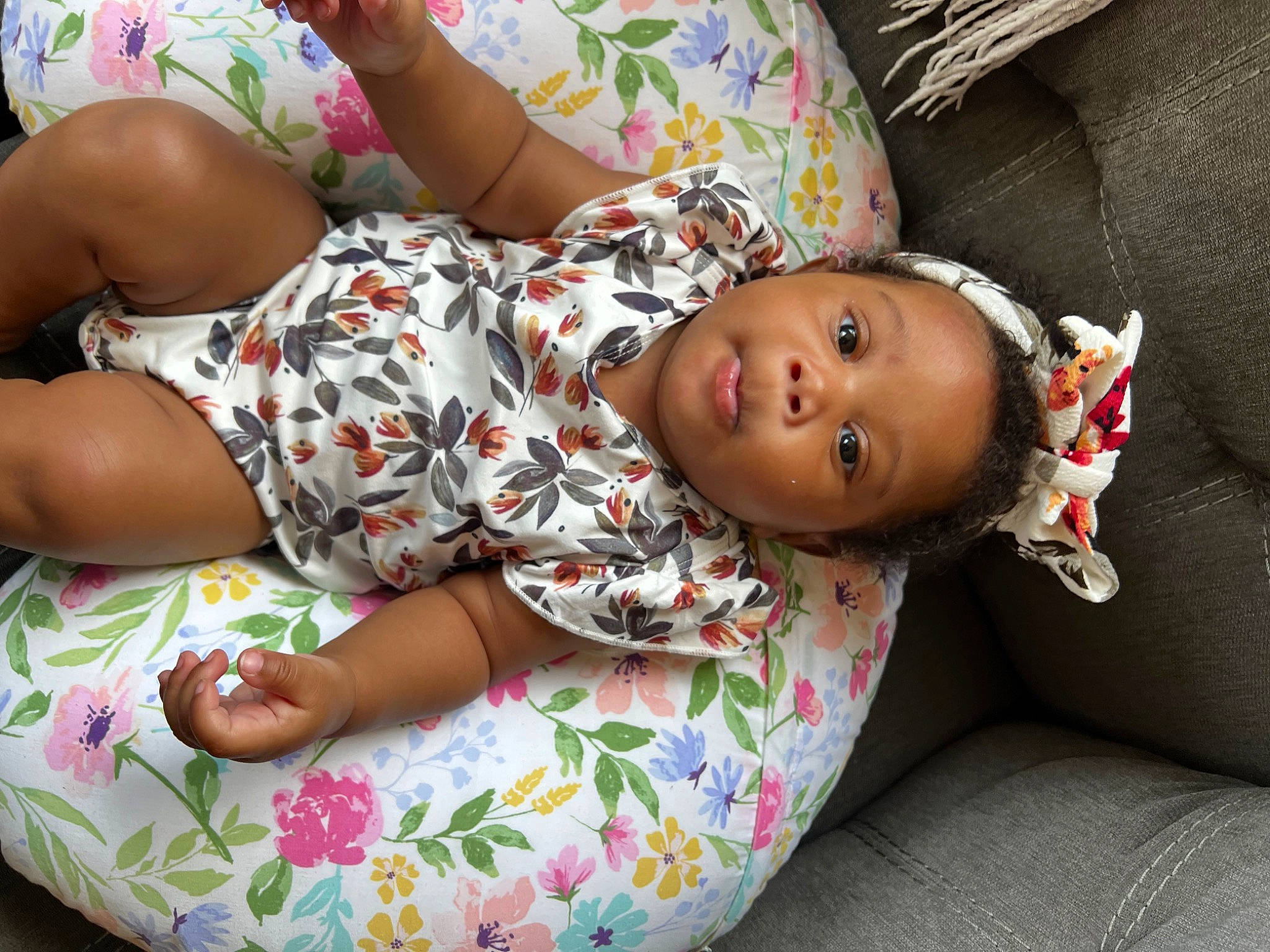 Kori joined the competition — help win amazing prizes! arm, baby, baby_toddler_clothing, child, comfort, couch, fun, head, human_body, human_leg, joint, leg, leisure, linens, mouth, pattern, person, sitting, skin, thigh