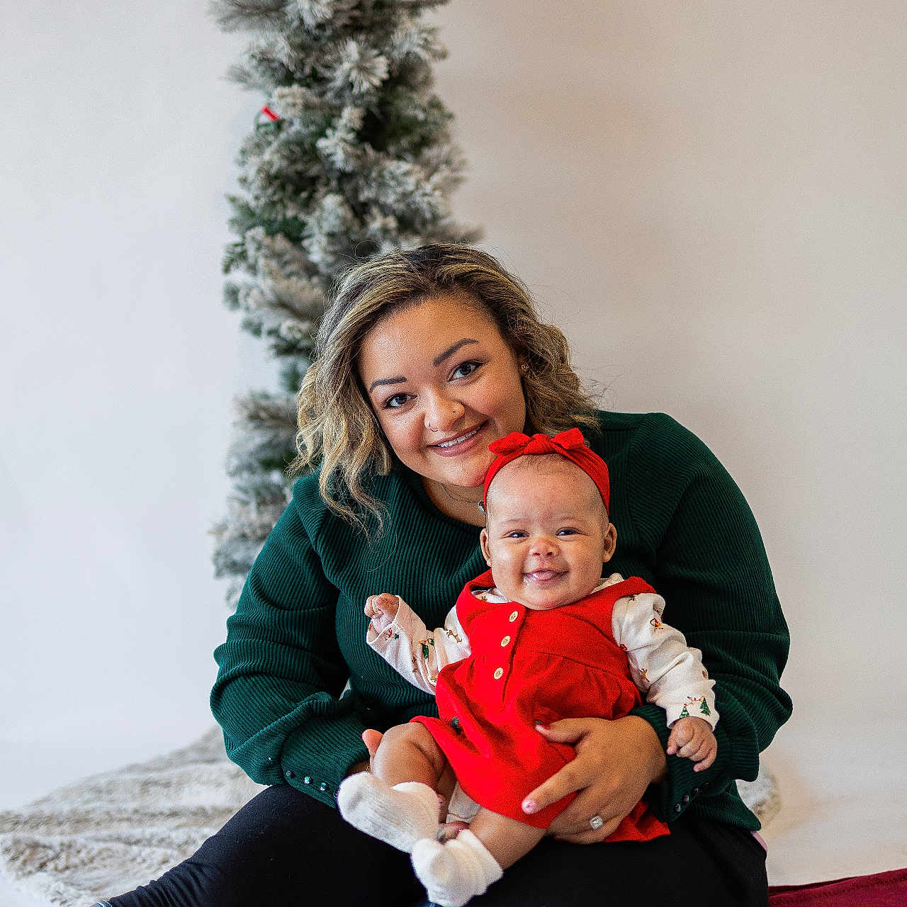 Amira is registered to the contest to win money with this photo: accessories, baby, bodypart, clothing, couch, face, finger, furniture, hand, happy, head, jewelry, pants, person, photography, plant, portrait, ring, smile, tree