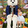 basket, butterfly, carrot, child, costume, cute, decorations, dress, easter_bunny, egg, flower, grass, holiday, indoor, mascot, pastel_colors, person, smile, spring, stool