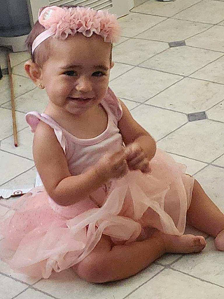Dezirae joined the competition — help win amazing prizes! baby, baby_toddler_clothing, bridal_accessory, child, dress, embellishment, fashion_accessory, flooring, foot, hair_accessory, happy, headband, headpiece, human_leg, jewellery, joy, peach, person, pink, sitting