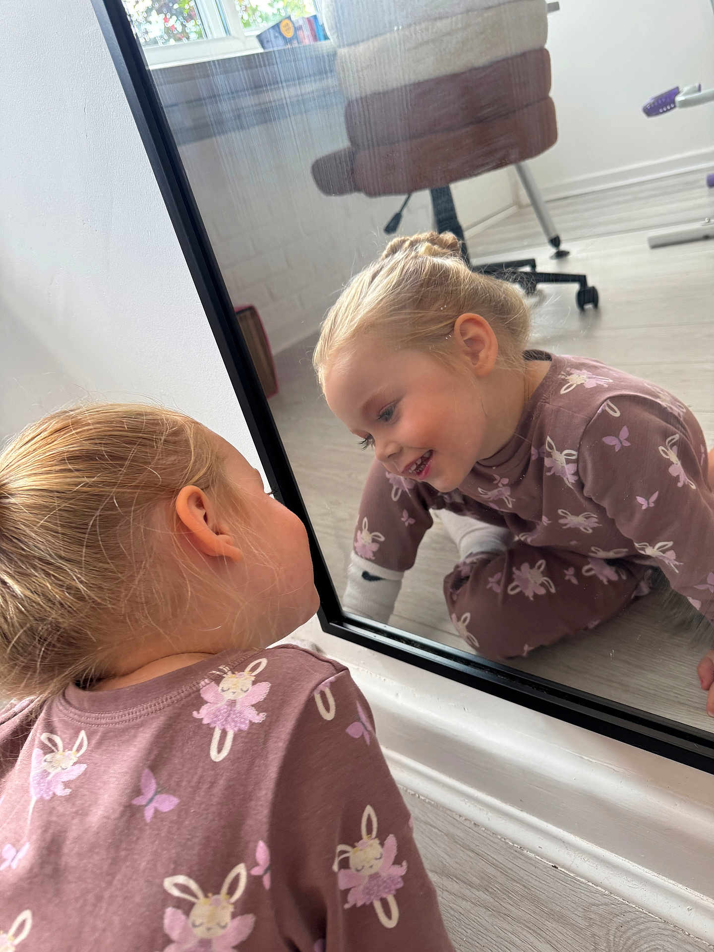 Connie-Rose joined the competition — help win amazing prizes! child, girl, mirror, reflection, indoor, floor, clothing, pattern, purple, bunny, smile, hair, blonde, room, chair, window, wood_floor, playful, happy, casual