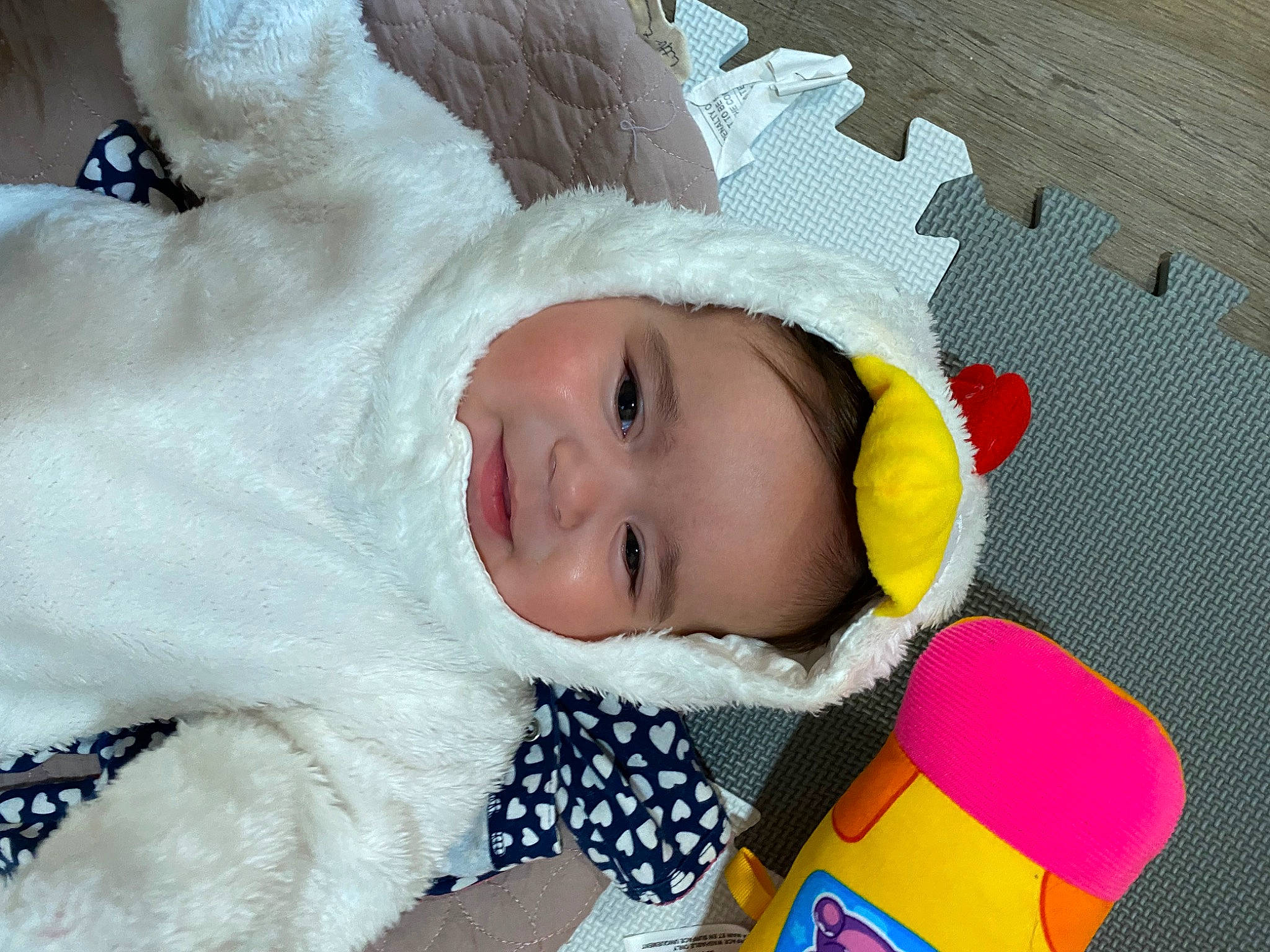 Sianna is registered to the contest to win money with this photo: baby, baby_products, baby_safety, baby_sleeping, baby_toddler_clothing, beanie, bedding, cheek, child, comfort, fun, fur, happy, headgear, linens, person, room, smile, textile, toddler