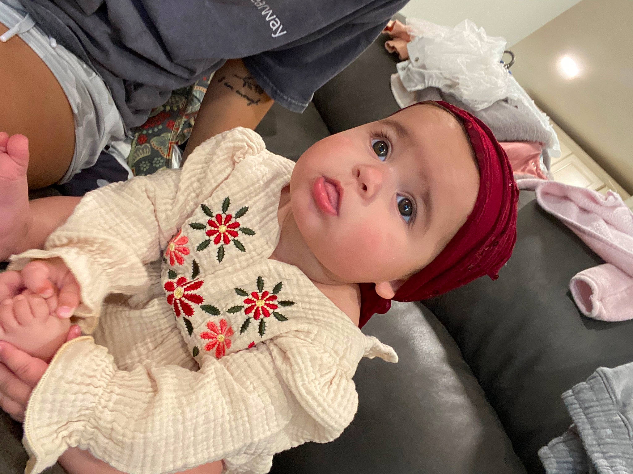 Sianna is registered to the contest to win money with this photo: baby, baby_toddler_clothing, cheek, child, comfort, fur, hand, happy, hat, headwear, human_body, pattern, person, sitting, skin, sleeve, textile, toddler, tradition, tree