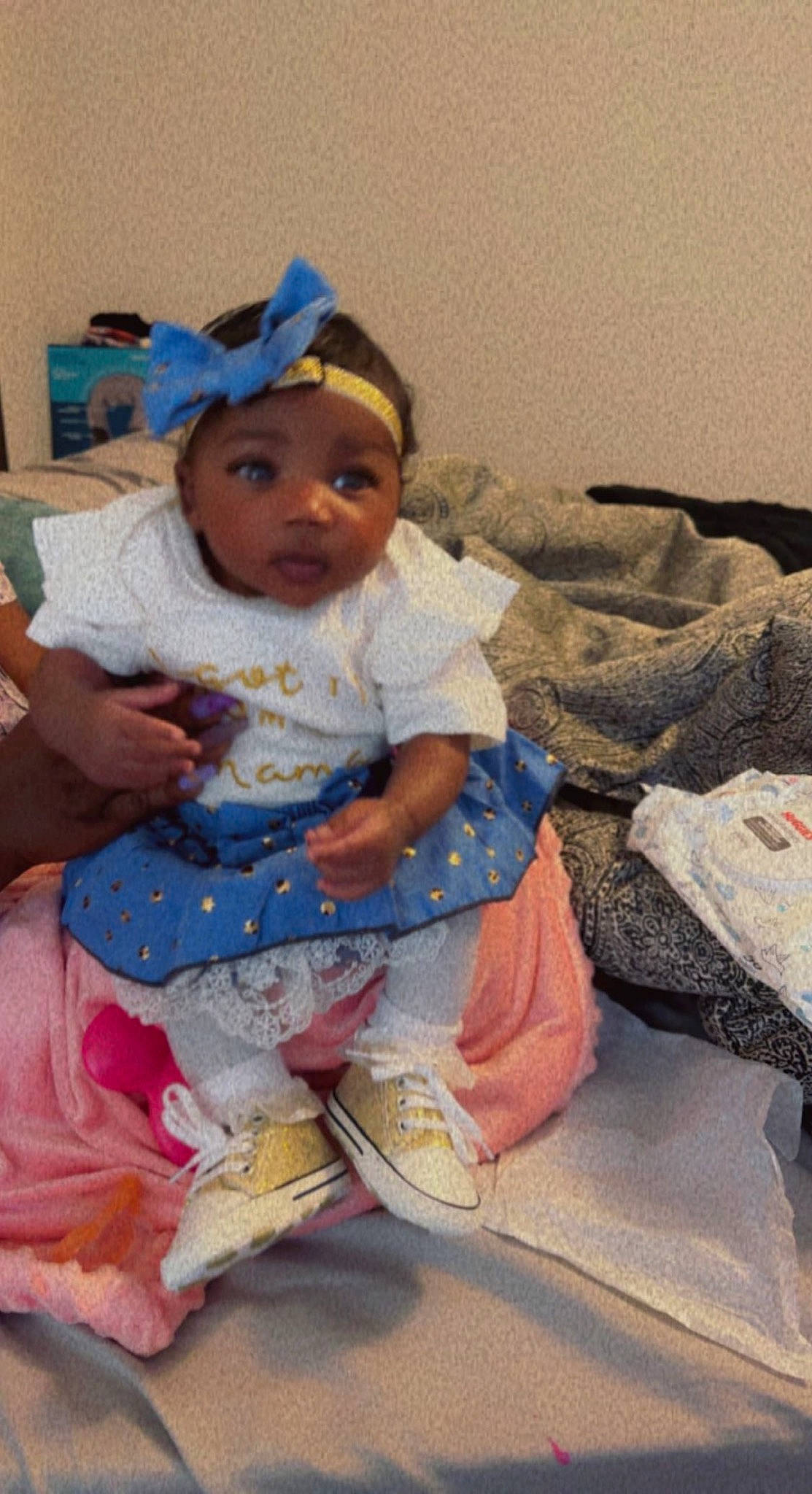 Royalty is registered to the contest to win money with this photo: baby, baby_products, baby_toddler_clothing, cheek, child, comfort, foot, fun, happy, hat, headwear, human_leg, lap, pattern, person, room, sitting, skin, sleeve, sock