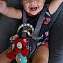 Jackson a rejoint le concours — aidez-le/la à gagner de superbes lots ! baby, smiling, child, toy, baby_chair, harness, clothing, indoor, happy, cute, person, seat, infant, playful, red, black, face, arms_up, comfort, joy
