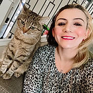 Hyper joined the competition — help win amazing prizes! blonde_hair, cat, companion, couch, earrings, friendly, furniture, happy, home_interior, indoor, leopard_print, makeup, necklace, pet, portrait, railing, seated, smile, tabby_cat, woman