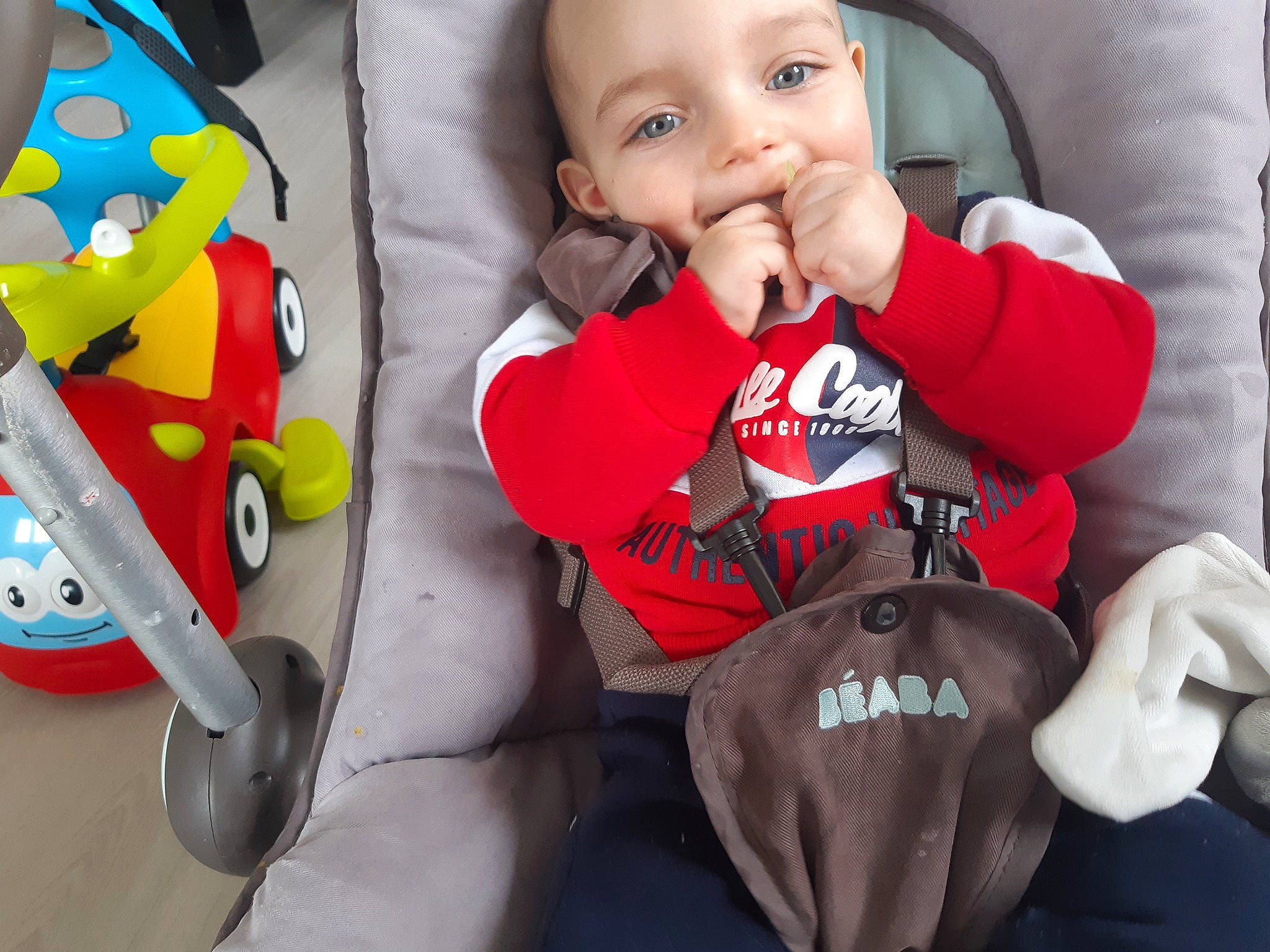 James participe au concours pour gagner de l'argent avec cette photo : baby, baby_products, baby_safety, baby_toddler_clothing, cheek, child, comfort, face, facial_expression, happy, head, nose, organ, person, photograph, product, sitting, sleeve, snapshot, t_shirt