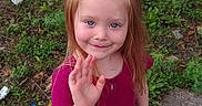 Bookie joined the competition — help win amazing prizes! child, girl, smiling, waving, portrait, outdoor, sidewalk, greenery, grass, flower_bow, red_hair, pink_shirt, jeans, black_shoes, standing, happy, face, long_hair, trailer, daylight