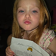 Bookie is registered to the contest to win money with this photo: blue_eyes, child, close_up, early_school_age, face, family_photo, flash_photography, floral_dress, girl, hands, indoors, long_hair, paper, portrait, pouting, red_hair, school_bus, school_information, serious_expression, sitting