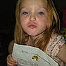 blue_eyes, child, close_up, early_school_age, face, family_photo, flash_photography, floral_dress, girl, hands, indoors, long_hair, paper, portrait, pouting, red_hair, school_bus, school_information, serious_expression, sitting
