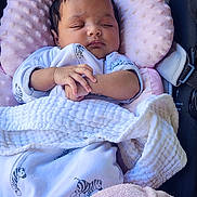 Lilith is registered to the contest to win money with this photo: baby, sleeping, blanket, pink, white, clothing, cushion, seat, infant, peaceful, resting, cozy, zebra_print, soft_texture, child, portrait, hands, cute, indoors, comfort