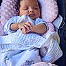 baby, sleeping, blanket, pink, white, clothing, cushion, seat, infant, peaceful, resting, cozy, zebra_print, soft_texture, child, portrait, hands, cute, indoors, comfort