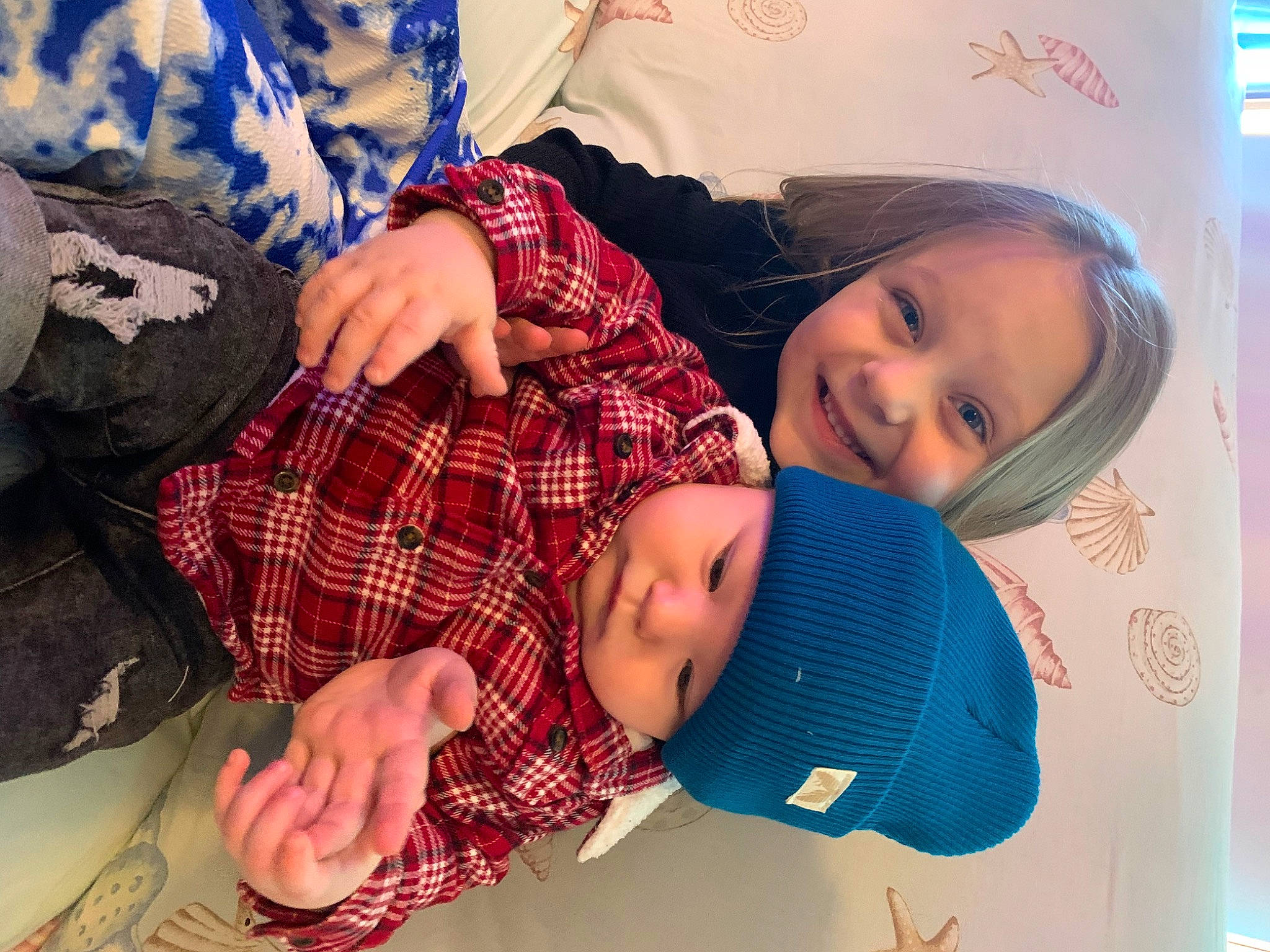 Layla is registered to the contest to win money with this photo: blue, cap, child, comfort, design, event, fashion_accessory, fun, happy, hat, headwear, joy, pattern, person, plaid, room, sleeve, smile, sun_hat, tartan