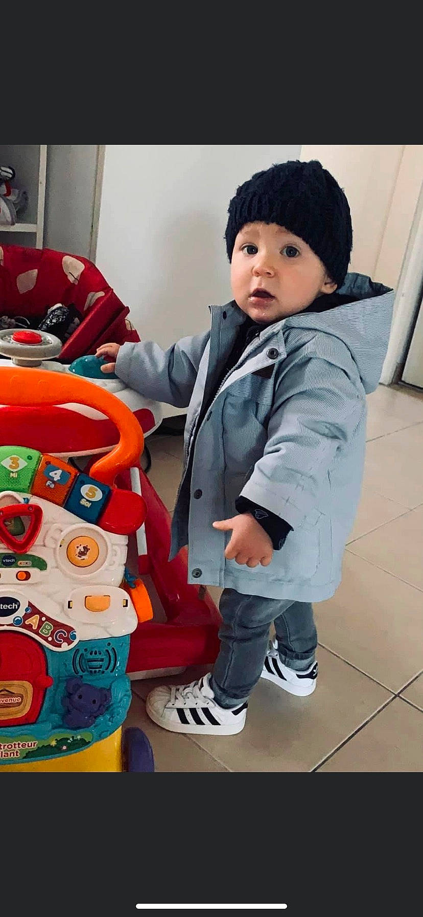 Aaron participe au concours pour gagner de l'argent avec cette photo : baby, baby_toddler_clothing, bag, boot, cap, cheek, child, flooring, fun, headwear, person, photograph, shoe, sitting, skin, sleeve, snapshot, sneakers, stuffed_toy, surprise