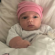 Talia participe au concours pour gagner de l'argent avec cette photo : baby, infant, pink_hat, blanket, pacifier, bed, bedding, clothing, face, person, cute, indoors, sleepwear, newborn, portrait, child, soft, cozy, expression, resting