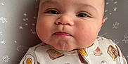 Calvin is registered to the contest to win money with this photo: baby, child, infant, onesie, crib, face, cheeks, expression, cute, sleepwear, milk_carton, egg_pattern, bacon_pattern, bread_pattern, stars, bedding, head, portrait, indoors, person