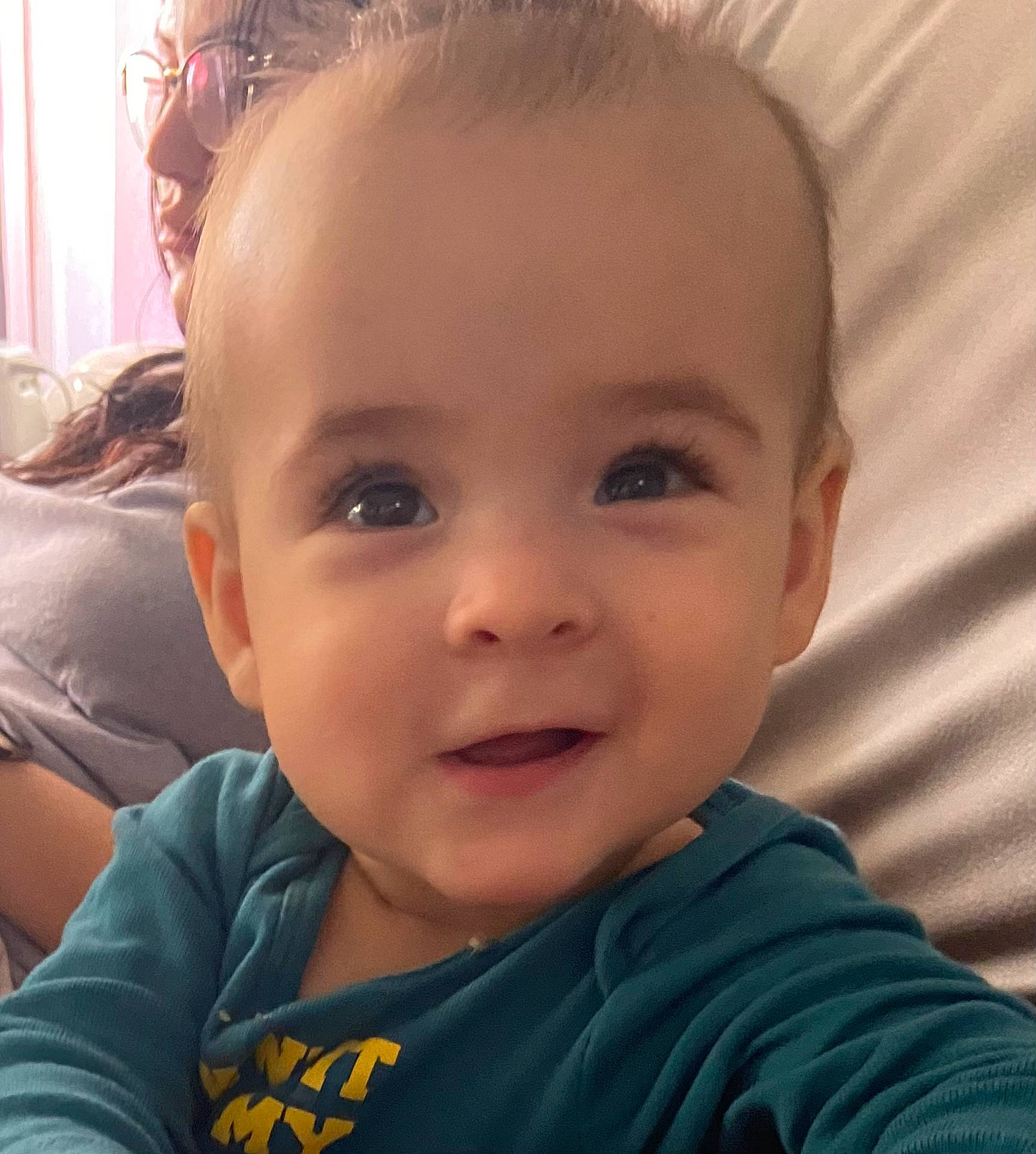 Mila is registered to the contest to win money with this photo: baby, cheek, chin, cool, ear, eyebrow, eyelash, facial_expression, finger, forehead, happy, iris, joy, lip, mouth, neck, nose, person, skin, sleeve