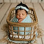 Aitana joined the competition — help win amazing prizes! newborn, baby, sleeping, basket, blue_blanket, headband, wooden_floor, cozy, portrait, infant, wrapped, cute, peaceful, indoors, soft_texture, baby_clothing, homedecor, baby_pose, baby_face, resting