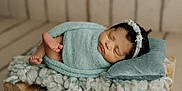 Aitana is registered to the contest to win money with this photo: newborn, baby, sleeping, blue_blanket, headband, wooden_bed, pillow, soft_texture, cozy, indoors, floor, carpet, cute, infant, wrapped, peaceful, portrait, small_bed, resting, child