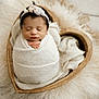 newborn, baby, swaddled, sleeping, headband, white_wrap, heart_shaped_bowl, fur, soft_texture, cozy, peaceful, infant, portrait, closeup, indoors, cute, hands, resting, blanket, adorable