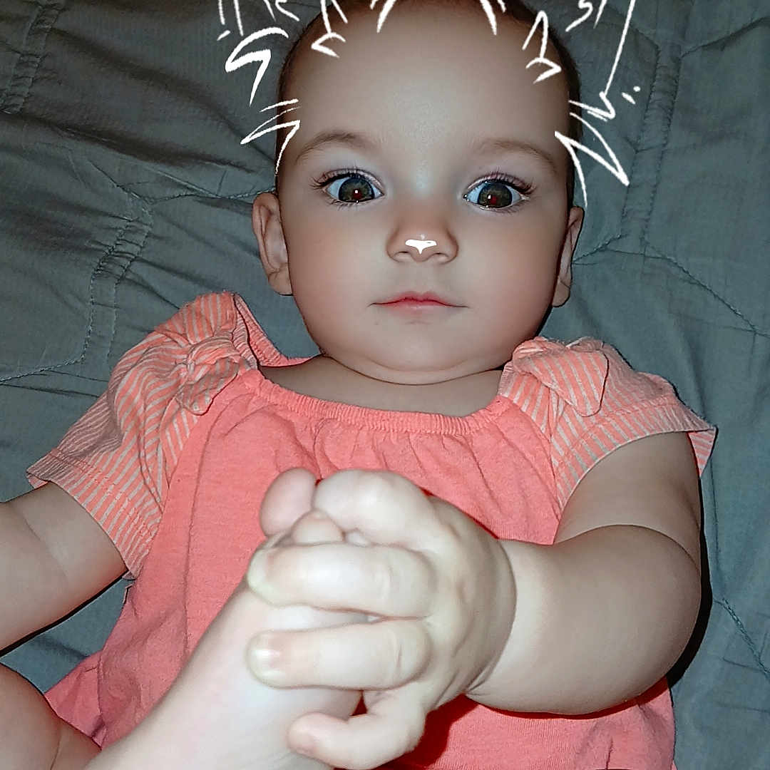 Abraylee is registered to the contest to win money with this photo: baby, bed, blanket, cat_ears, child, clothing, cute, doodle, expressionless, eyes, face, filter, foot, hand, indoor, infant, person, shorts, skin, top
