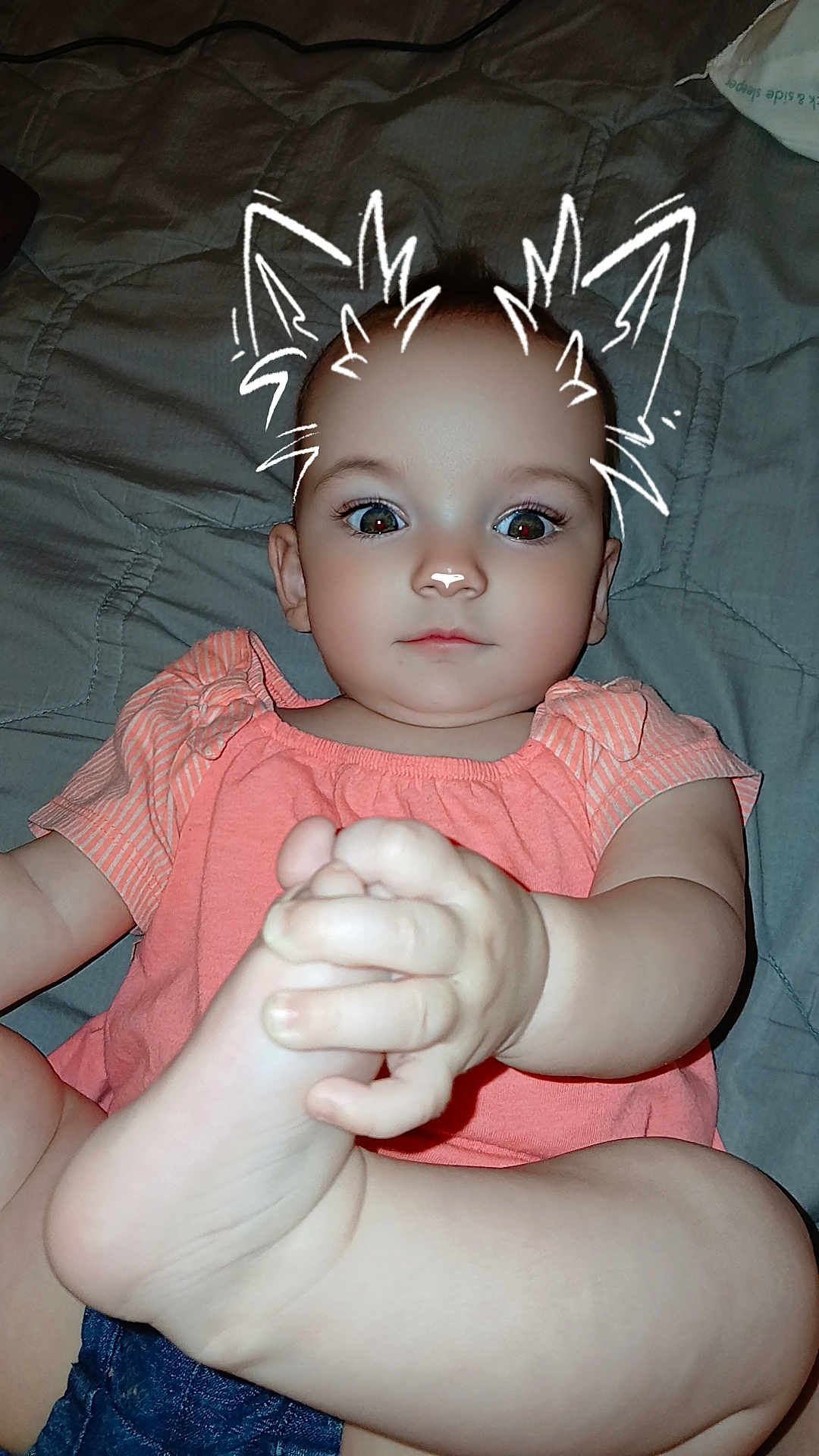 Abraylee is registered to the contest to win money with this photo: baby, child, infant, person, face, hand, foot, clothing, top, shorts, bed, blanket, skin, eyes, expressionless, filter, doodle, cat_ears, indoor, cute