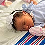Kylie joined the competition — help win amazing prizes! newborn, baby, sleeping, headband, flower, mittens, blanket, blue_outfit, infant, soft, peaceful, cute, portrait, closeup, child, indoors, resting, baby_clothes, newborn_baby, toddler