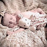 Vera is registered to the contest to win money with this photo: baby, sleeping, headband, bow, plush_toy, bunny, blanket, knit, soft_toy, infant, cute, cozy, pink, floral, fabric, child, peaceful, portrait, indoors, resting