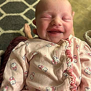 Addison joined the competition — help win amazing prizes! baby, babylaughing, blanket, clothing, coat, crying, face, glove, happy, head, jacket, newborn, person, photography, portrait, quilt, skin, sleeping, smile, tattoo